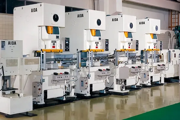 Row of metal stamping presses on the production floor